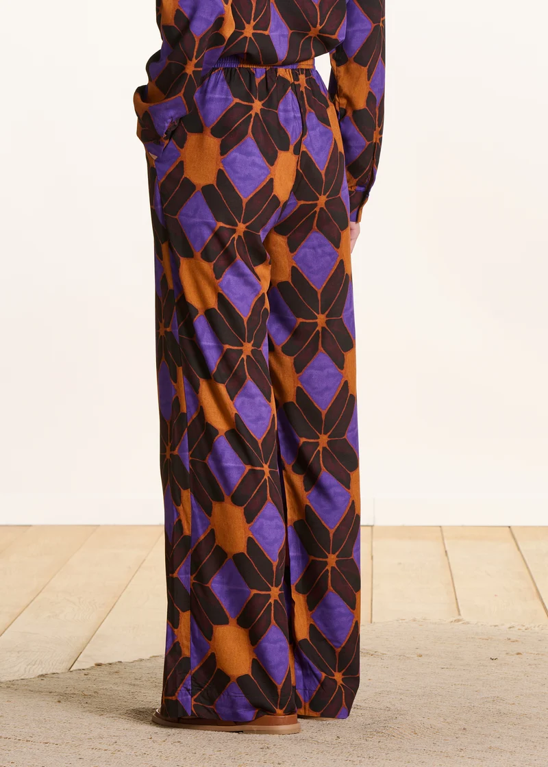 Pantalon large orange et violet à imprimé