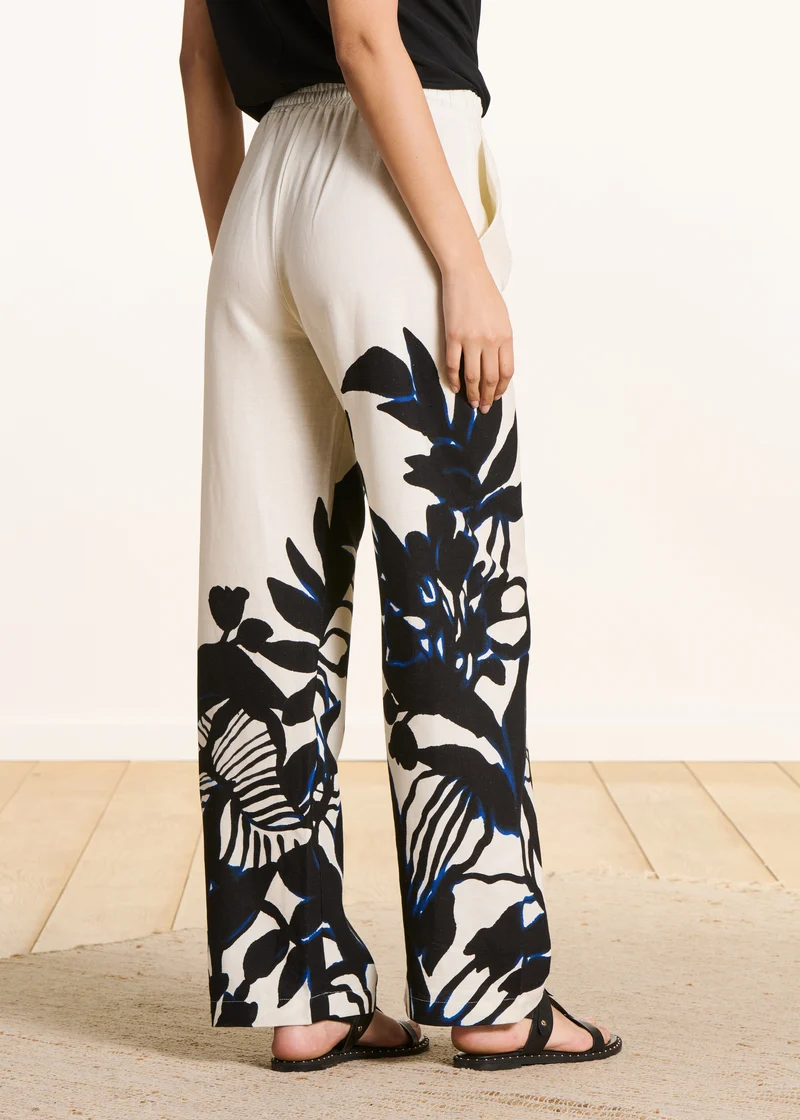 Pantalon écru fluide à imprimé floral noir